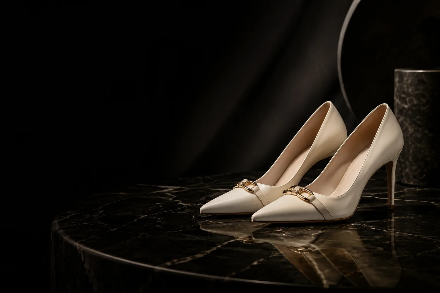 Ivory pumps on black marble