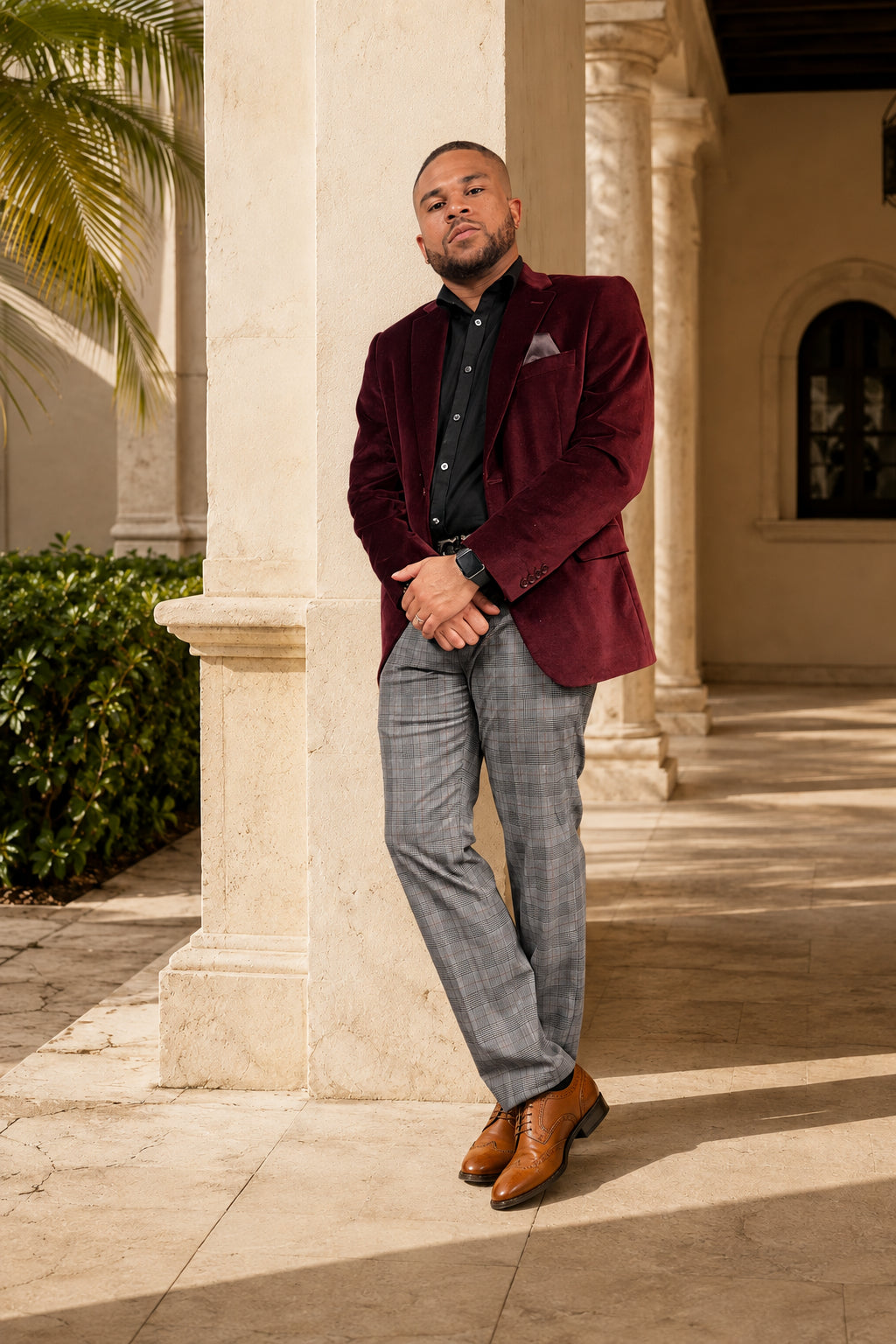 Dean, Shoe Monéa Men model, wearing a burgundy velvet blazer and black loafers